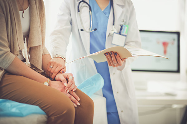 Doctor checking a woman's pulse